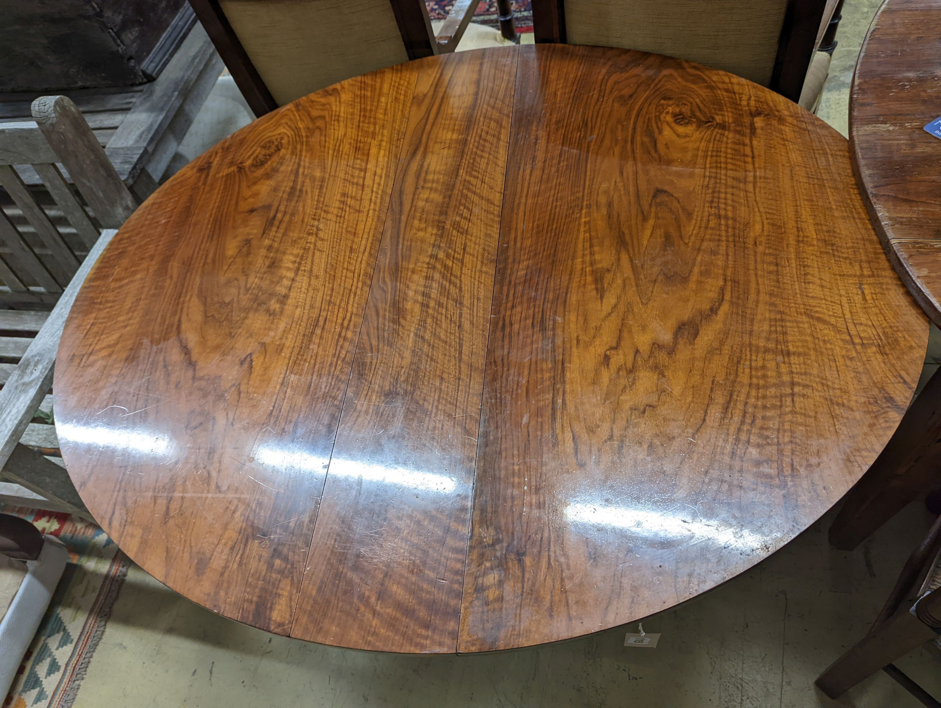 A Victorian figured walnut oval Sutherland table, width 100cm, length 118cm extended, height 72cm